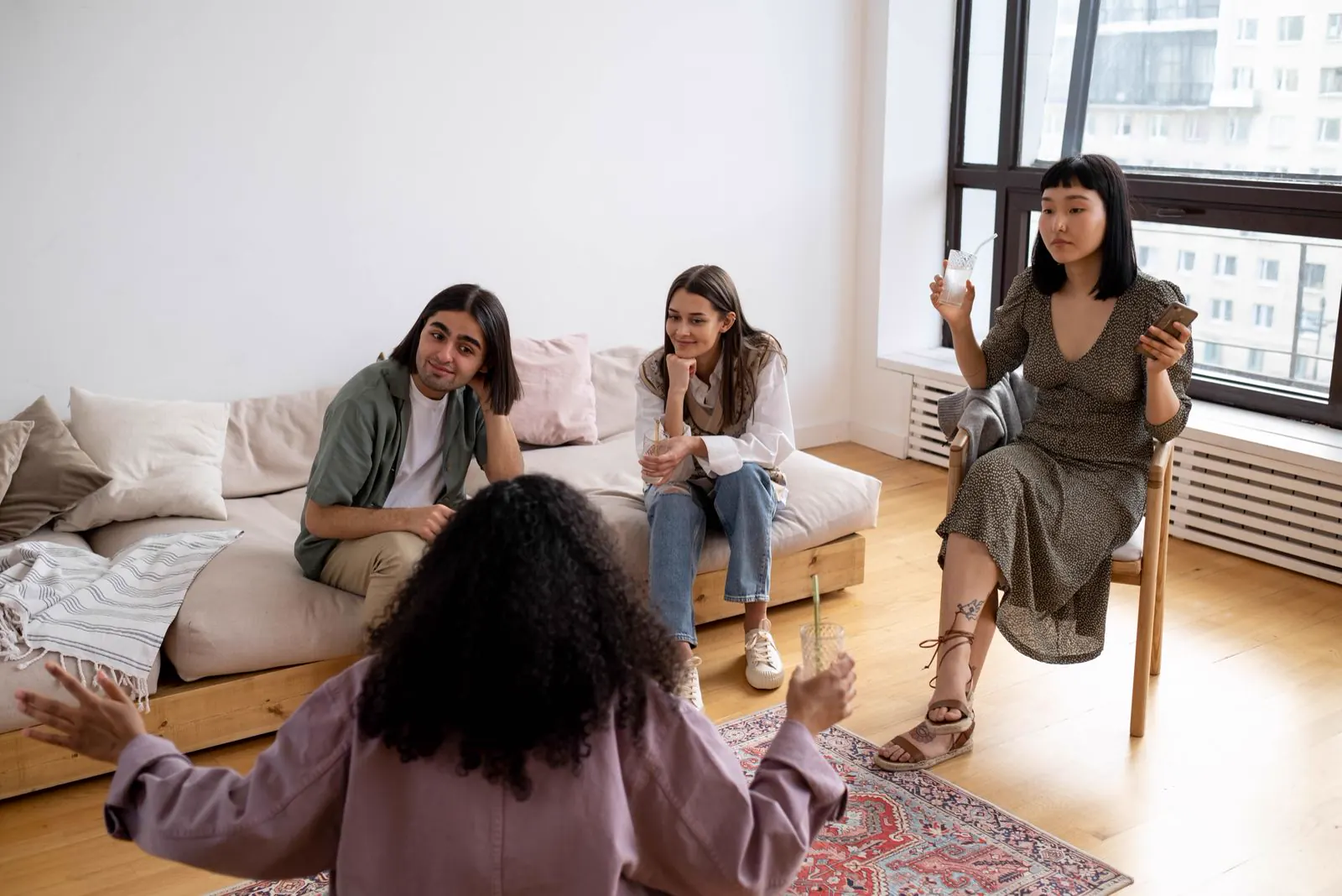 Groupe d’amis réunis dans un salon lumineux pour illustrer un shooting coliving
