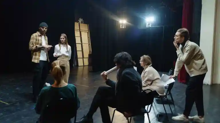 Comédiens et équipe en répétition sur une scène de théâtre